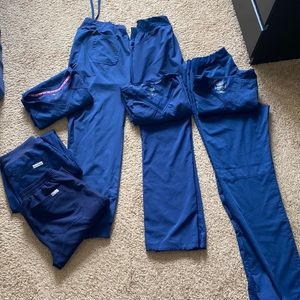 4 pair Navy blue scrubs. Figs, Cherokee, Med couture. Joggers and flare. S & xs